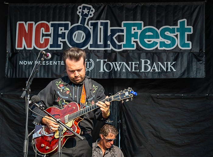 Guitar performer on stage at the NC Folk Festival.