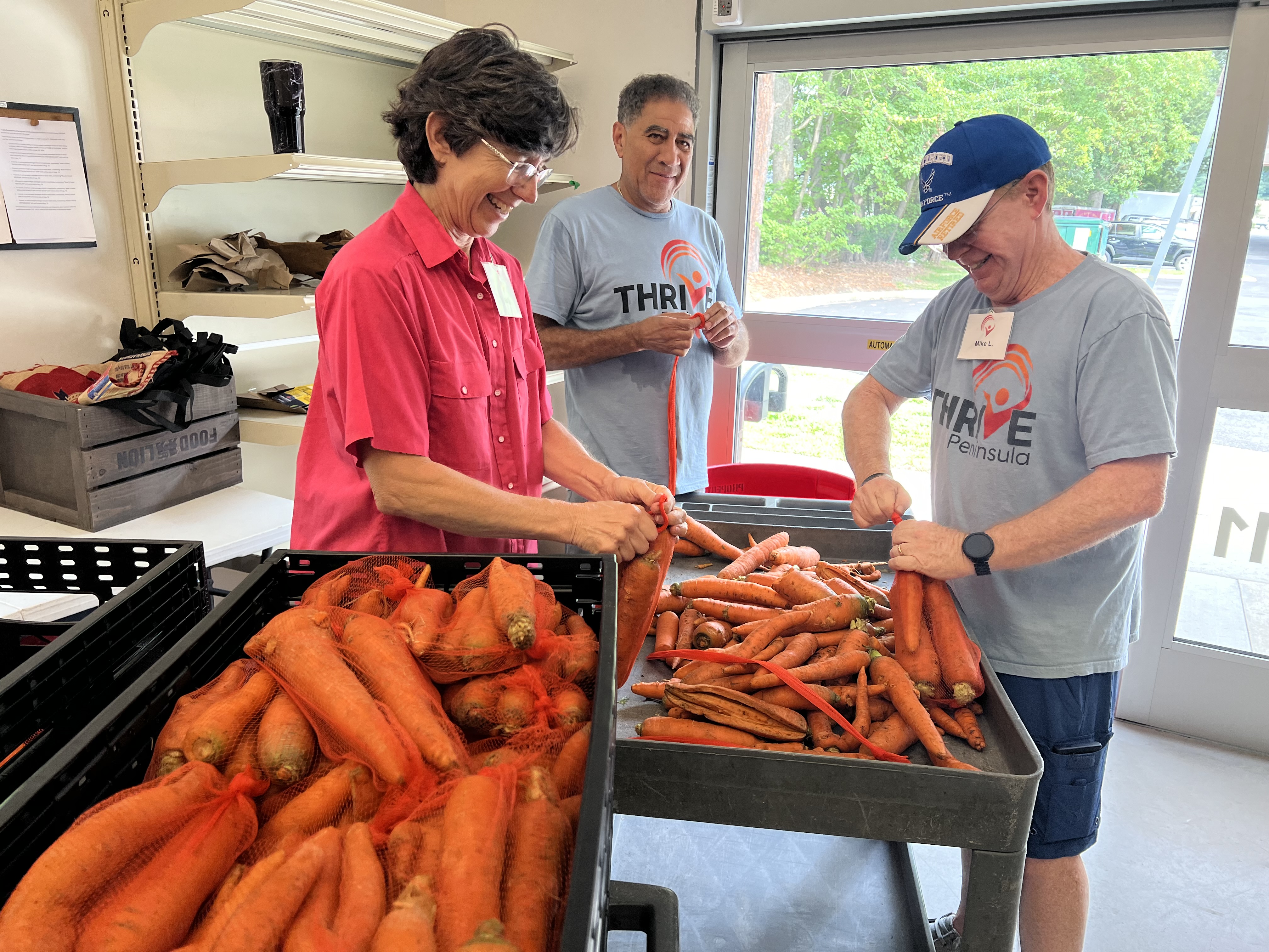 3 people washing carrots
