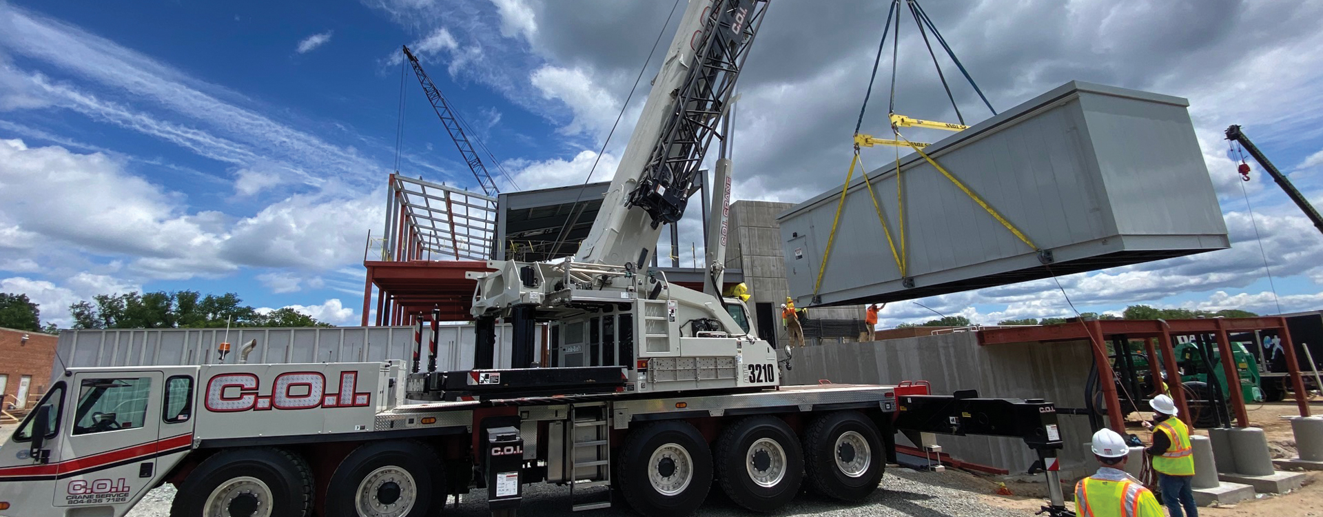 cranes lift large equipment onto building