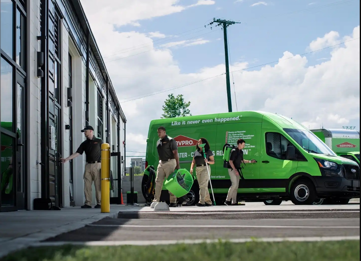 servpro truck with 4 people coming out of it