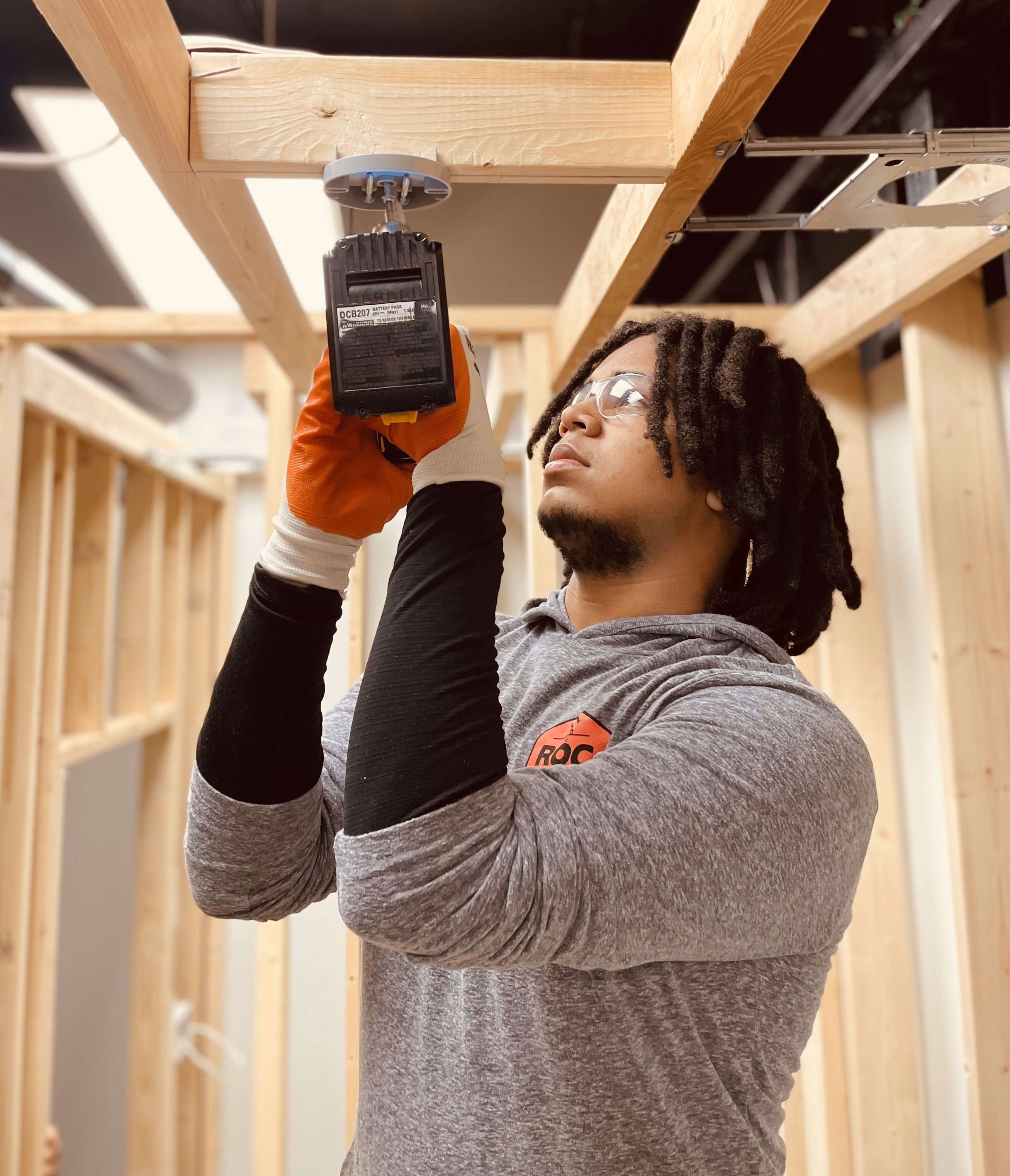 man with a drill working on a building