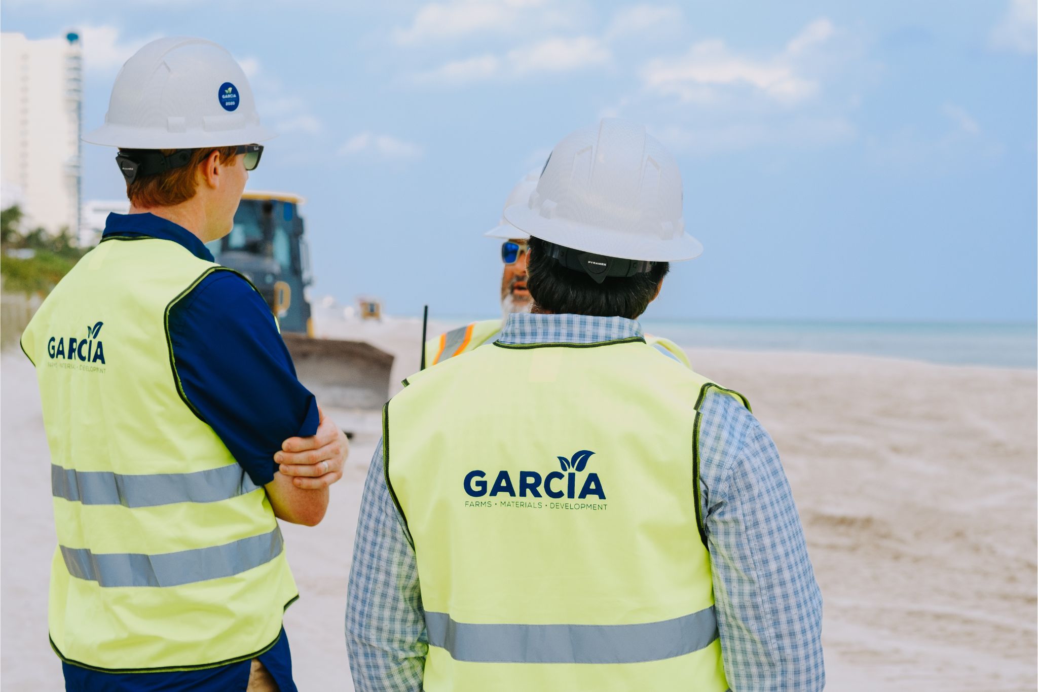 image of two guys facing away from the camera in construction outfits
