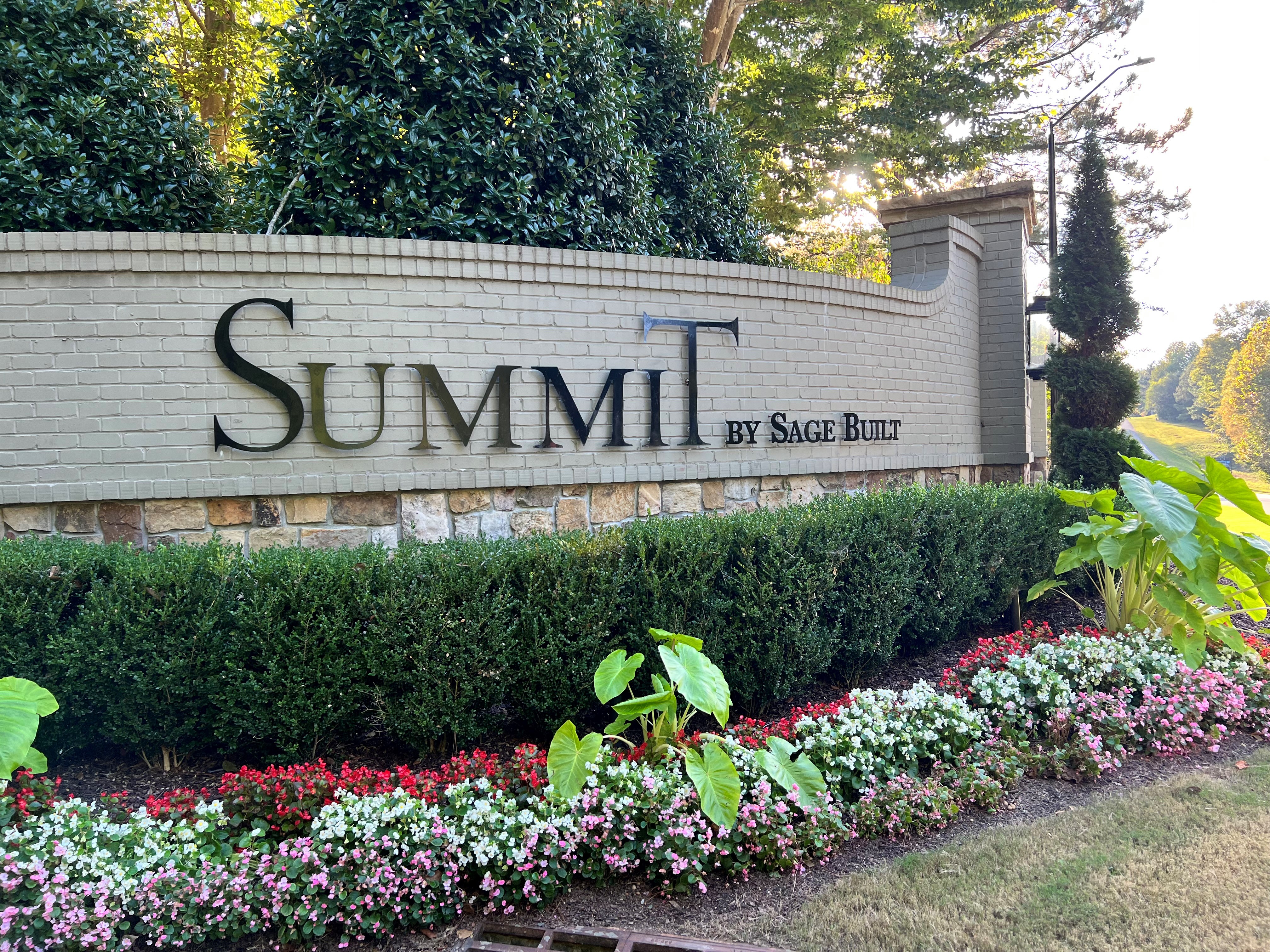 summit sign with flowers in front