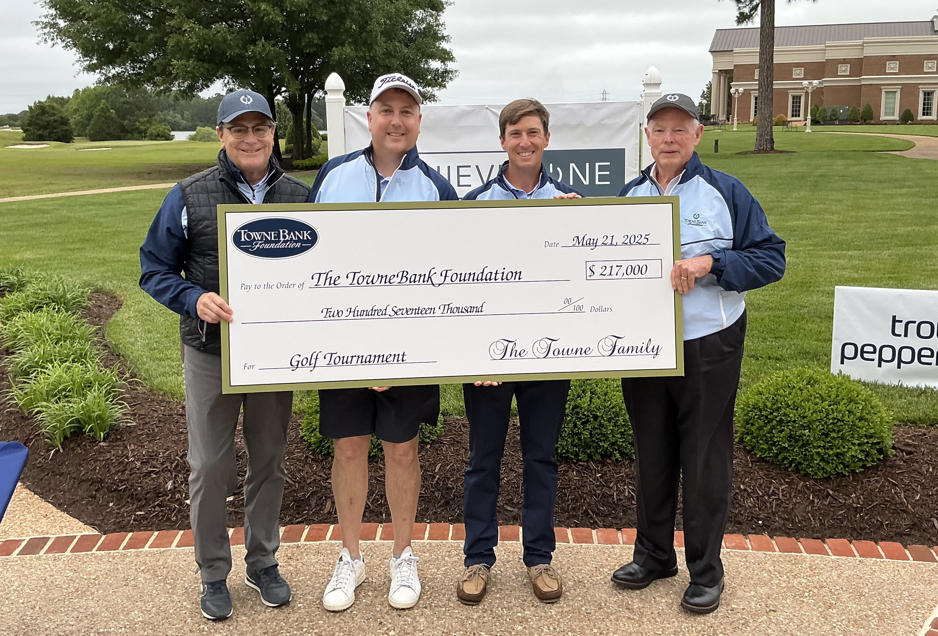 group photo holding a large check