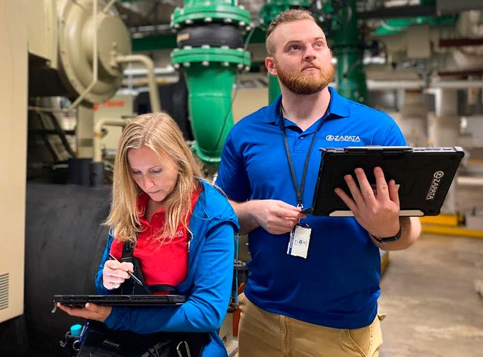 two people working with tablets in their hands