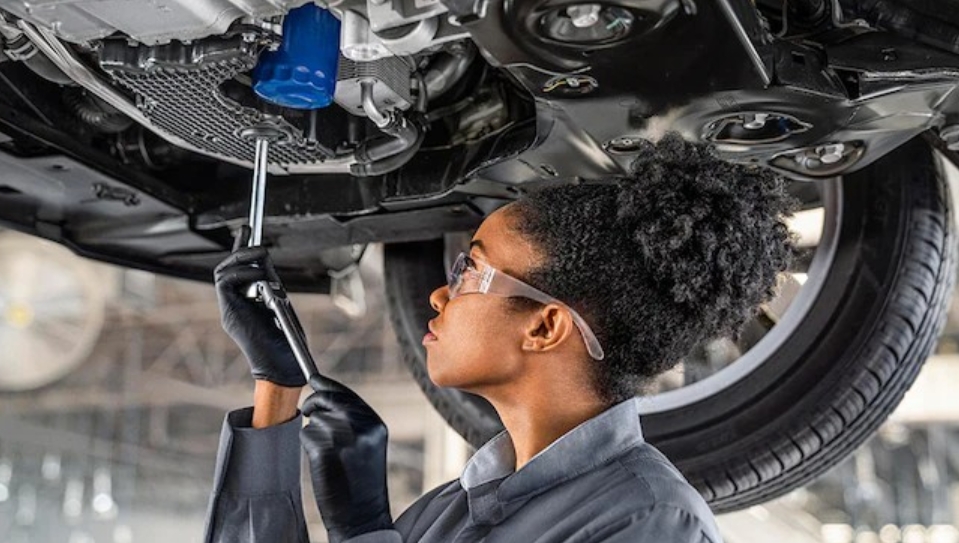 woman car tech working on a car