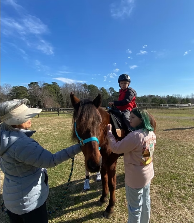3 people and a horse