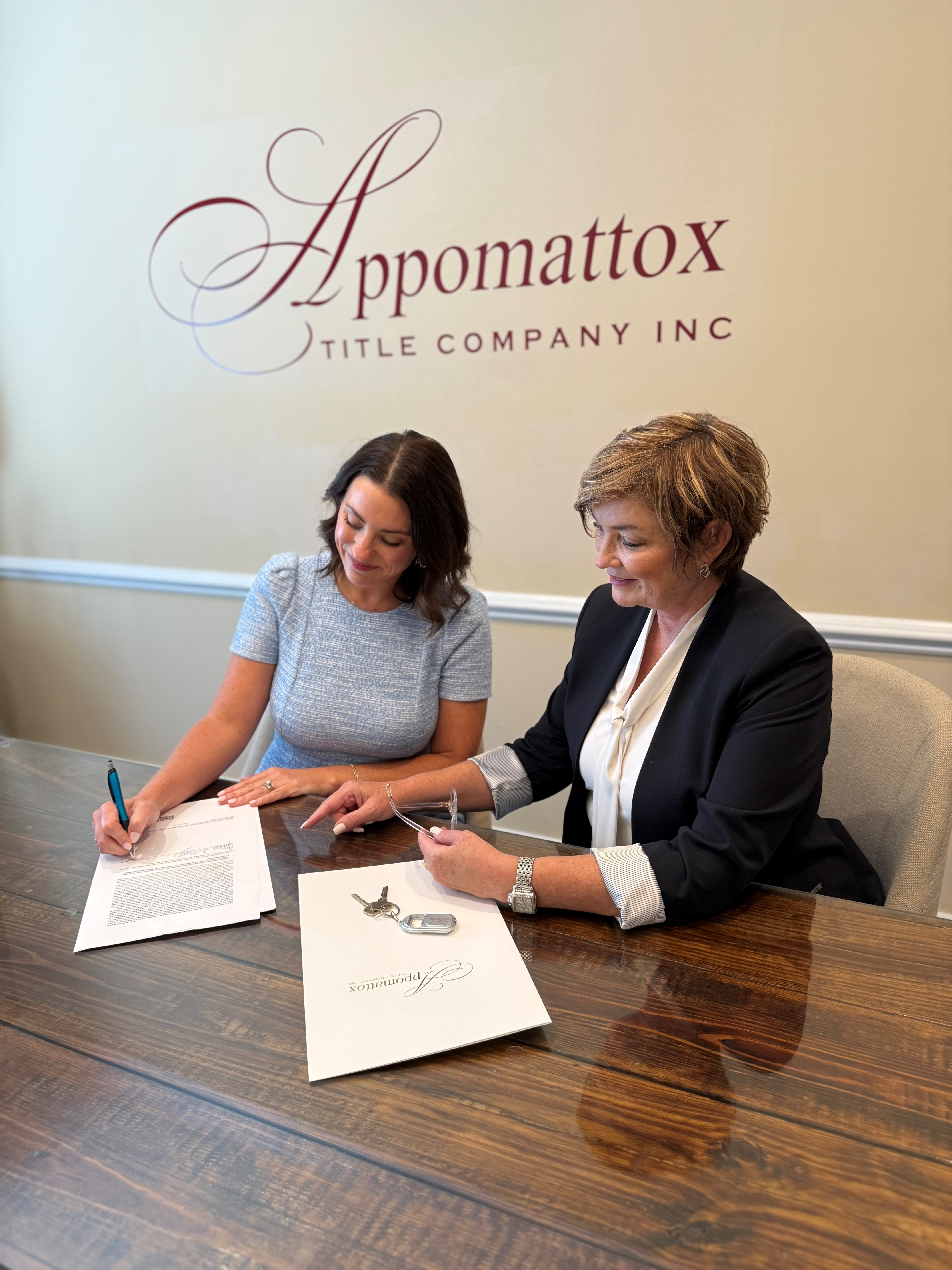 two women signing a piece of paper