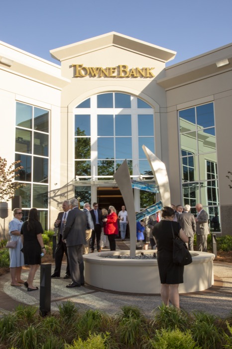 People in mingling in front of a building