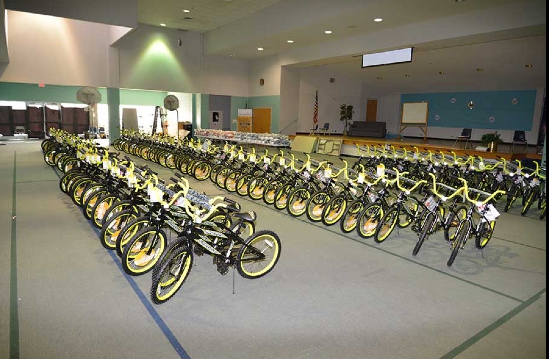 Rows of new kid bicycles in an auditorium.