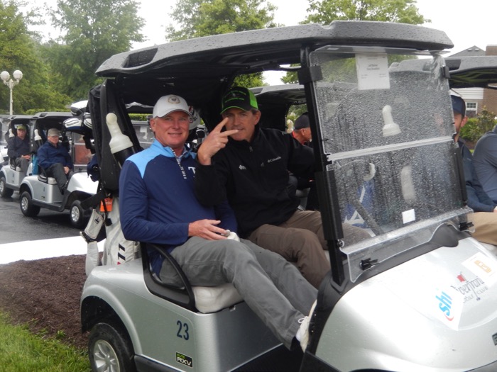 Two men in a golf cart.