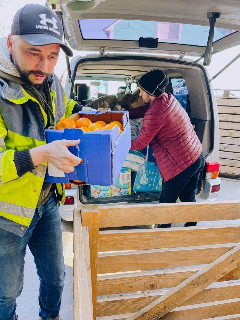 Volunteers moving boxes of fresh produce