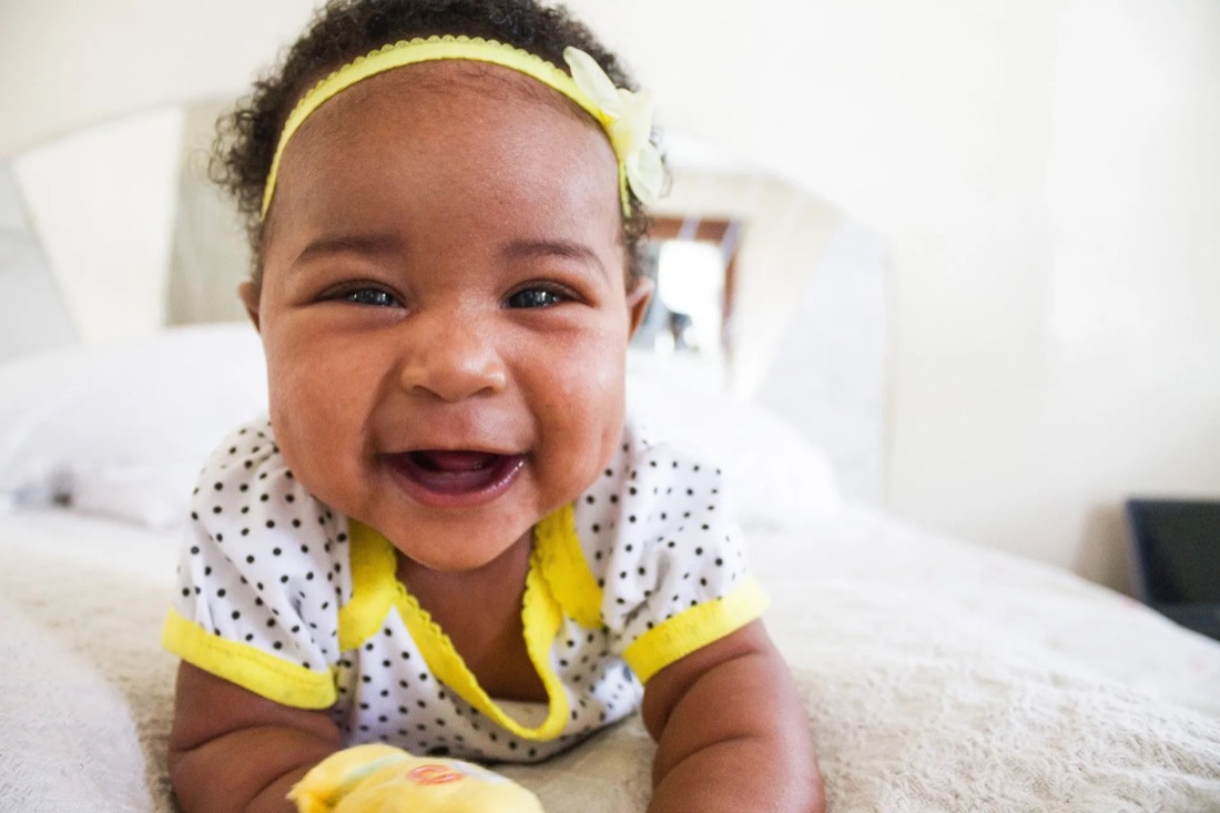 Close up photo of smiling baby.