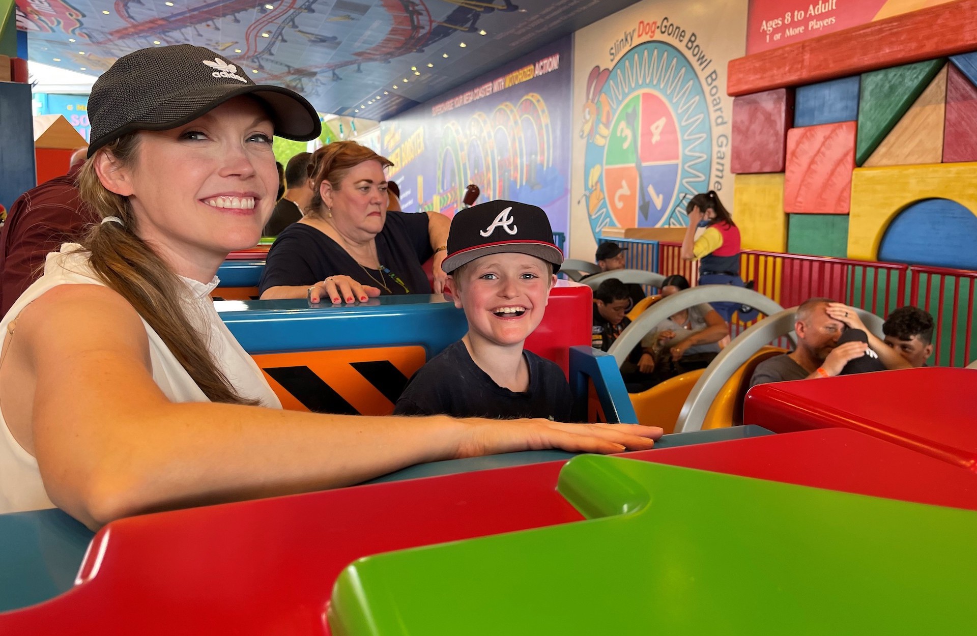 Close up photo of mother and son waiting in line at a theme park.